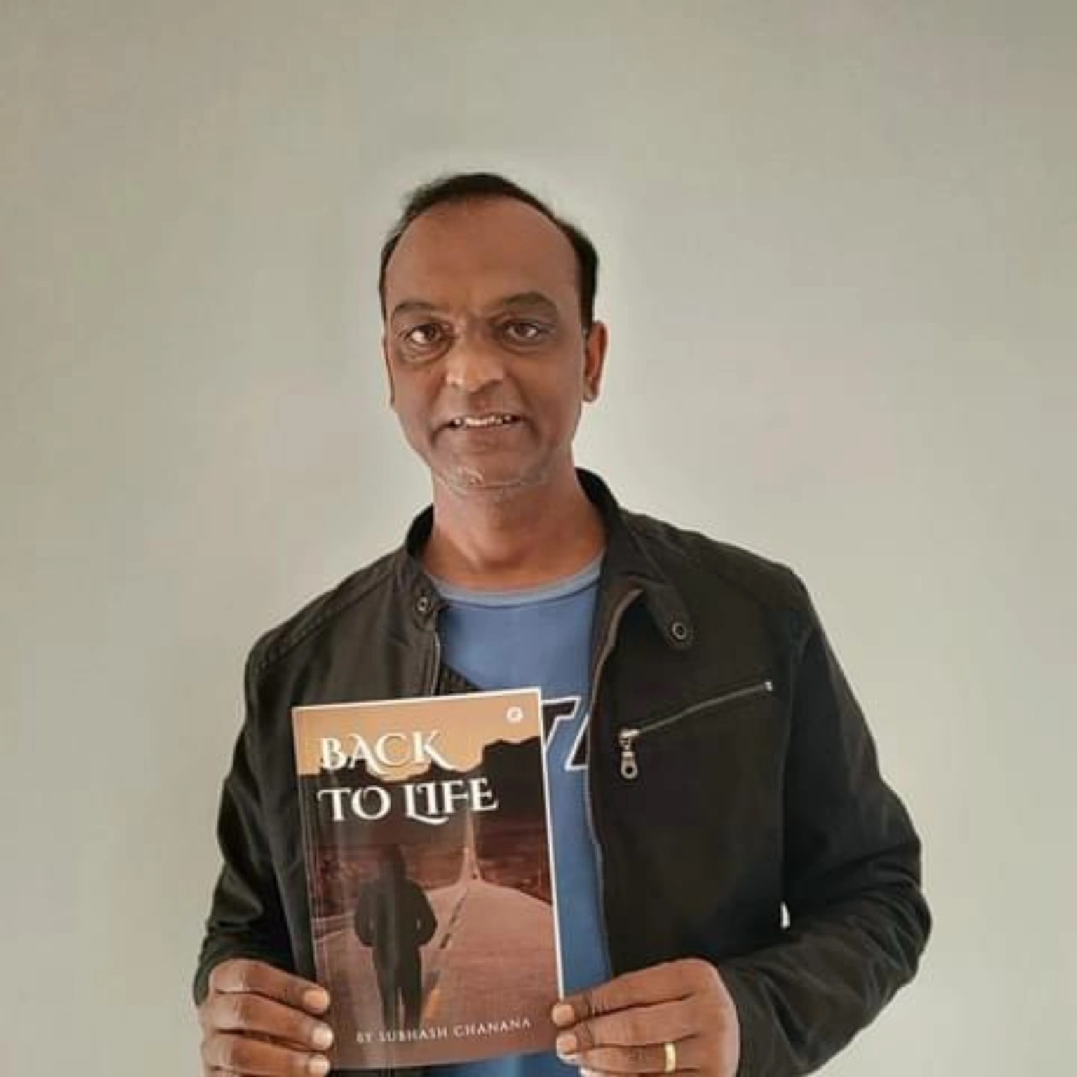Subhash Chanana holding his book